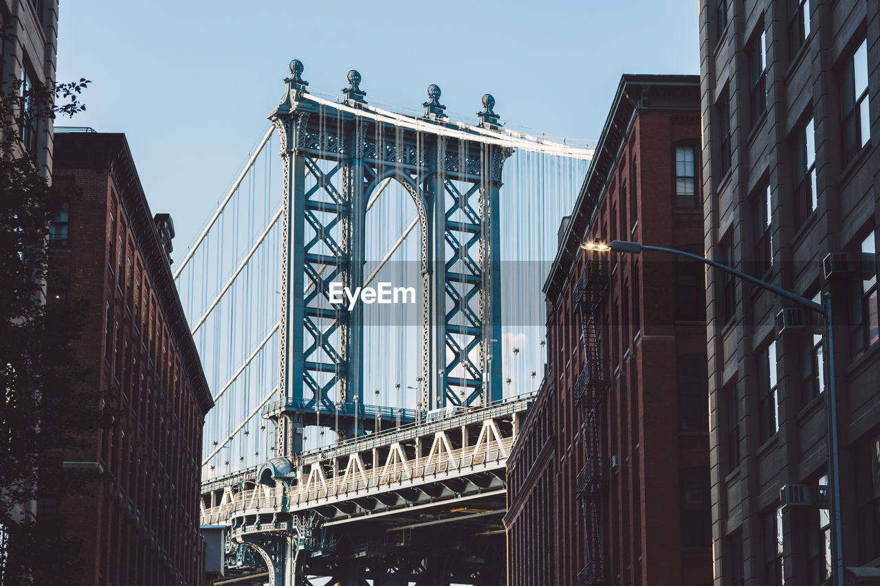 Low angle view of manhattan bridge against sky