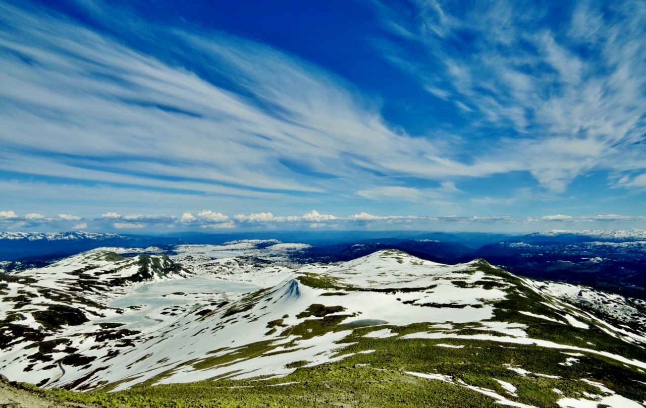 Scenic view of mountains against blue sky