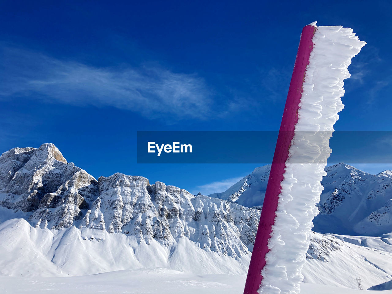 Snow covered mountain against blue sky