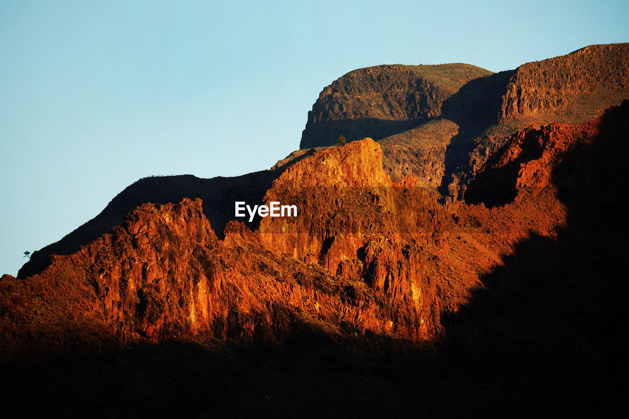 Low angle view of mountains against clear sky at canary islands