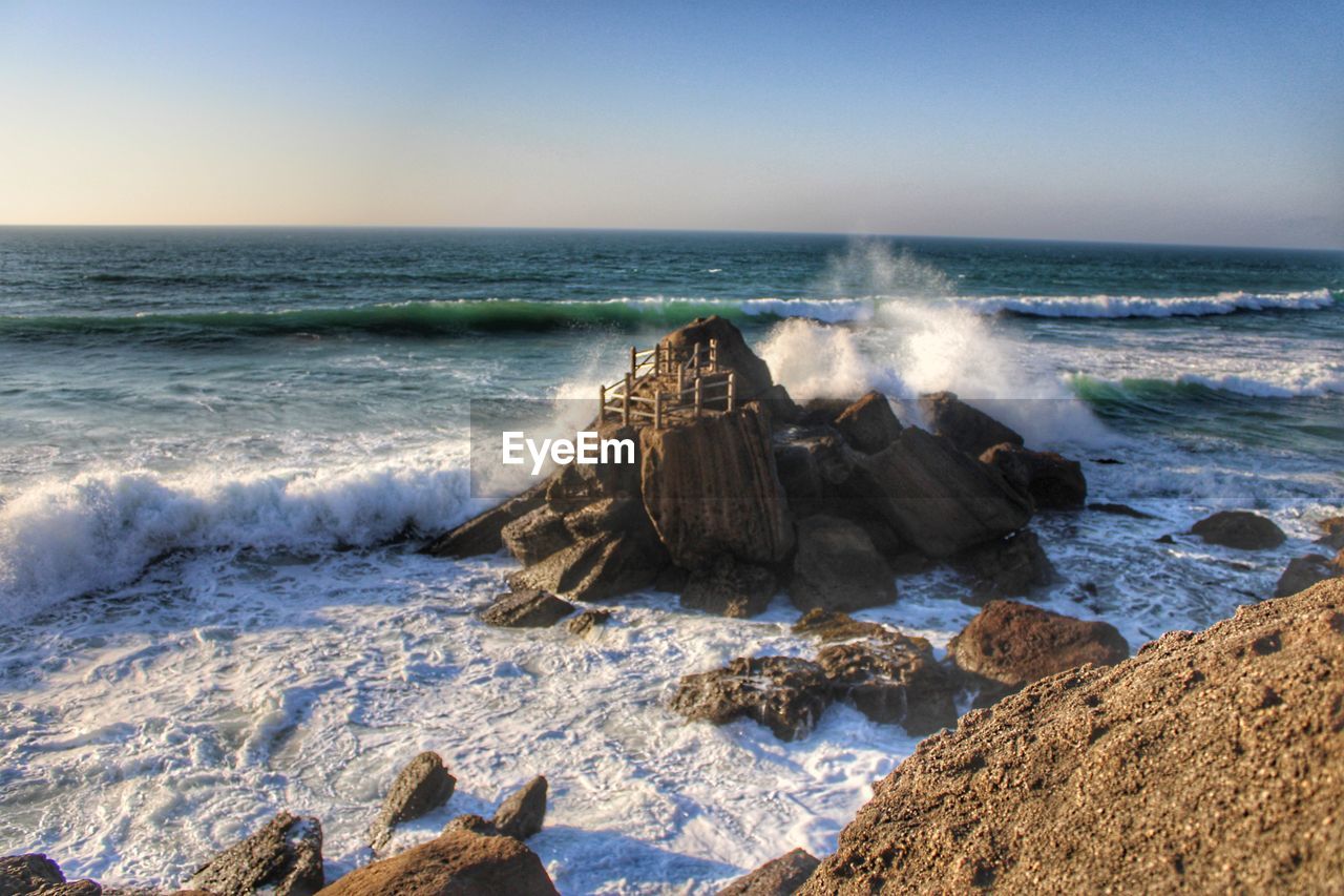 WAVES SPLASHING ON ROCKS AT SHORE