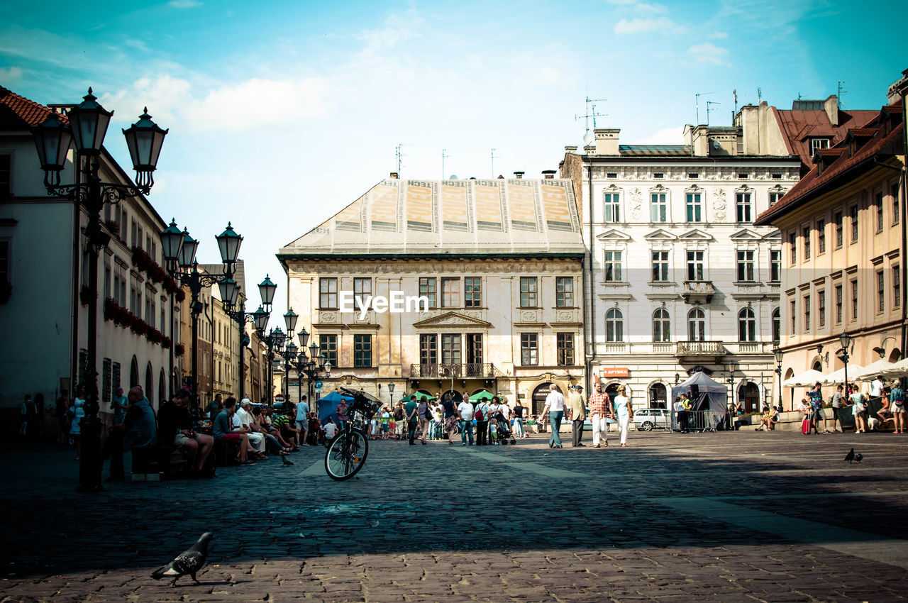 People on street against buildings in old town