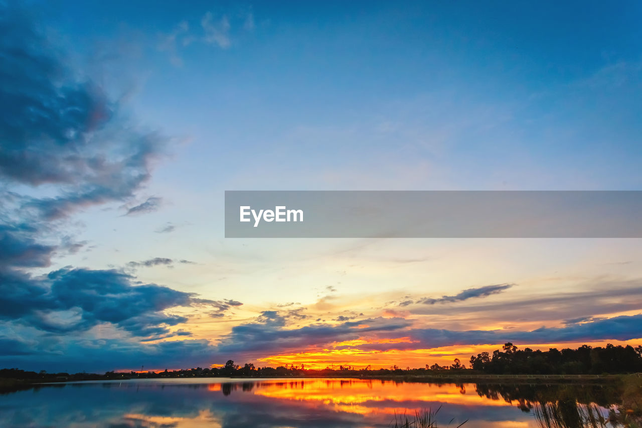 SCENIC VIEW OF LAKE AT SUNSET