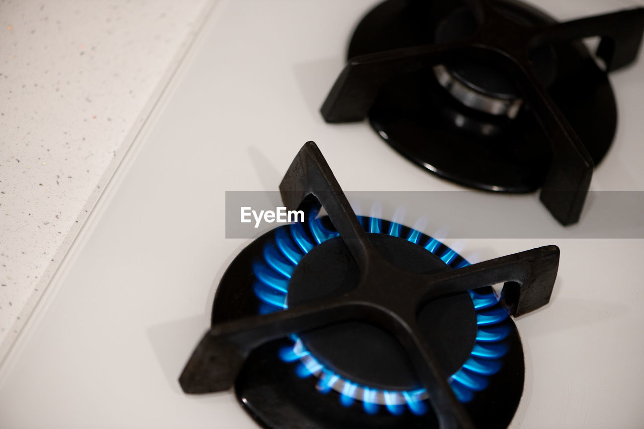 black, stove, burner - stove top, gas stove, indoors, appliance, kitchen, blue, high angle view, no people, fossil fuel, domestic kitchen, burning, close-up, power generation, domestic room, light, fire, glasses