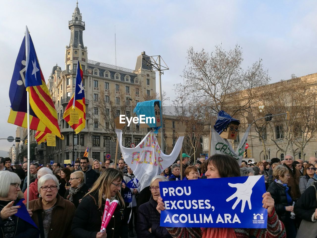 PEOPLE ON STREET AGAINST SKY