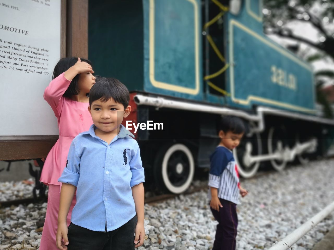 PORTRAIT OF A BOY STANDING ON TRAIN