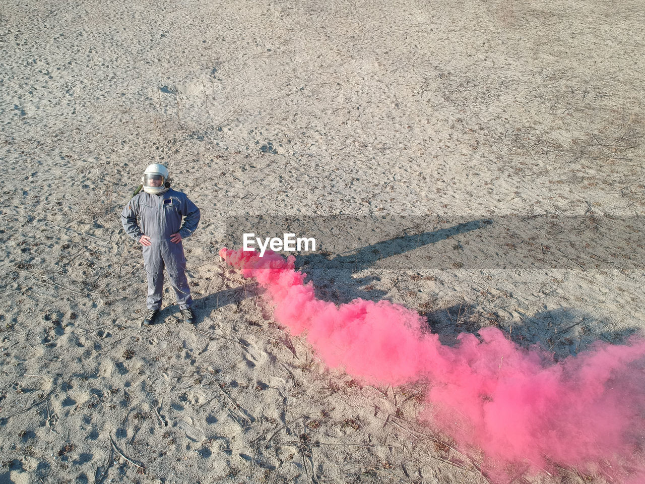 High angle view of man standing by distress flare on ground