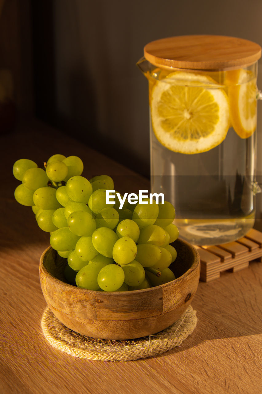 Green grapes lie on eco dish. eco-friendly choice and friendly nature. the concept of world without