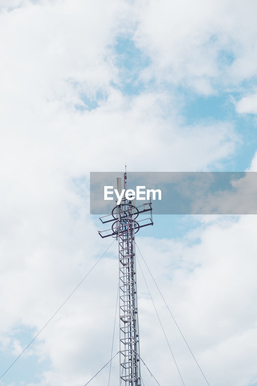 Low angle view of antenna and blue sky