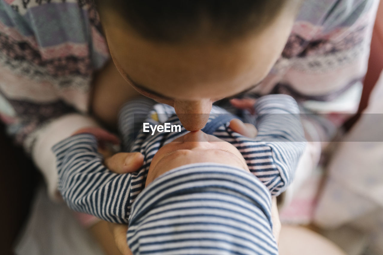 Mother rubbing nose with baby boy