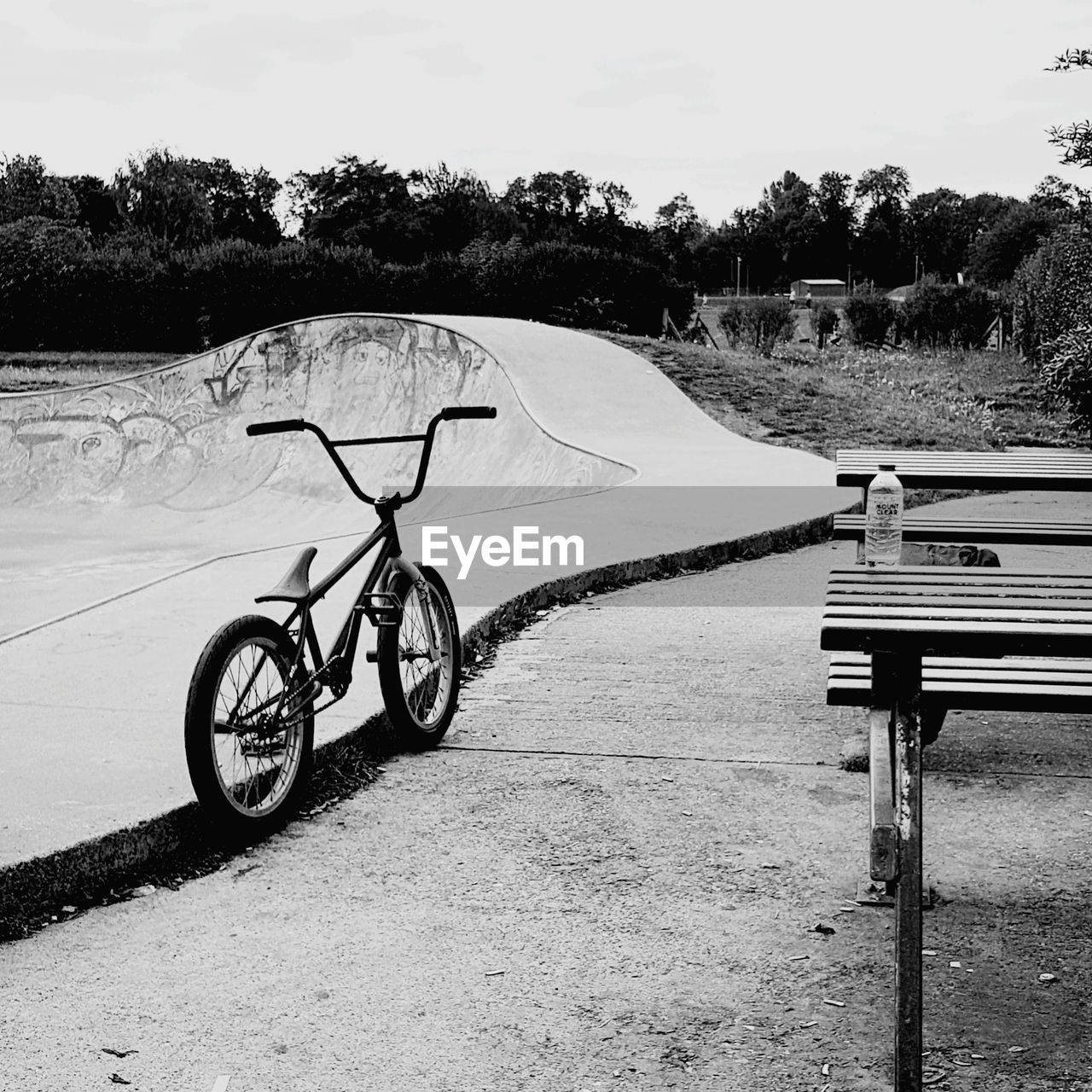 Bicycle by road against sky