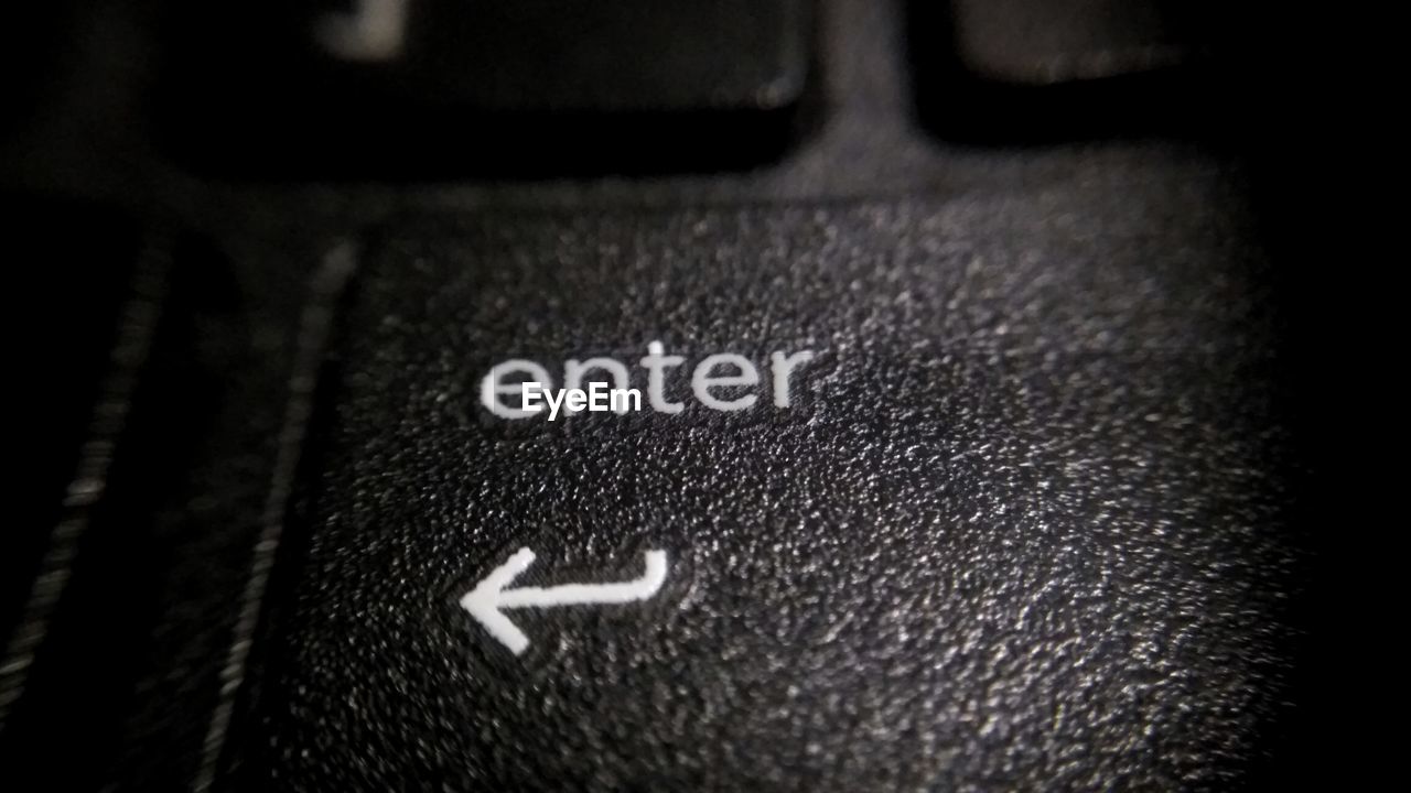 Close-up of enter text with arrow symbol on computer keyboard