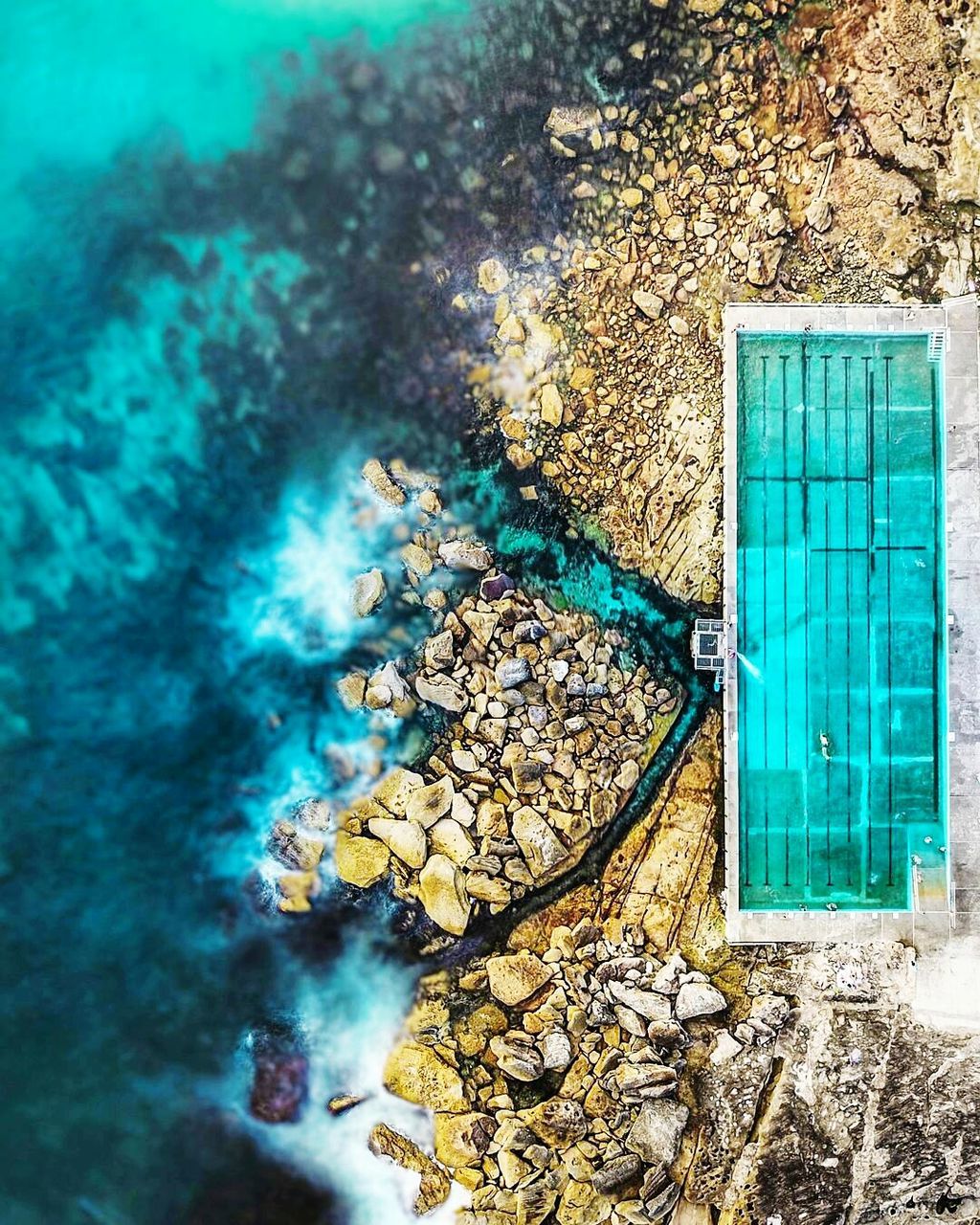 Aerial view of infinity pool by turquoise sea