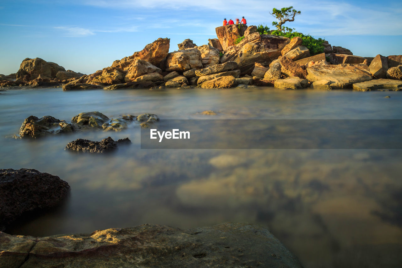 Scenic view of sea and rock formation against sky