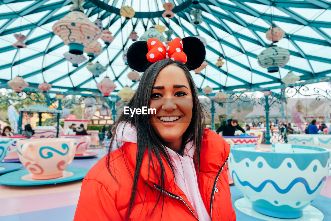 Portrait of smiling young woman at amusement park