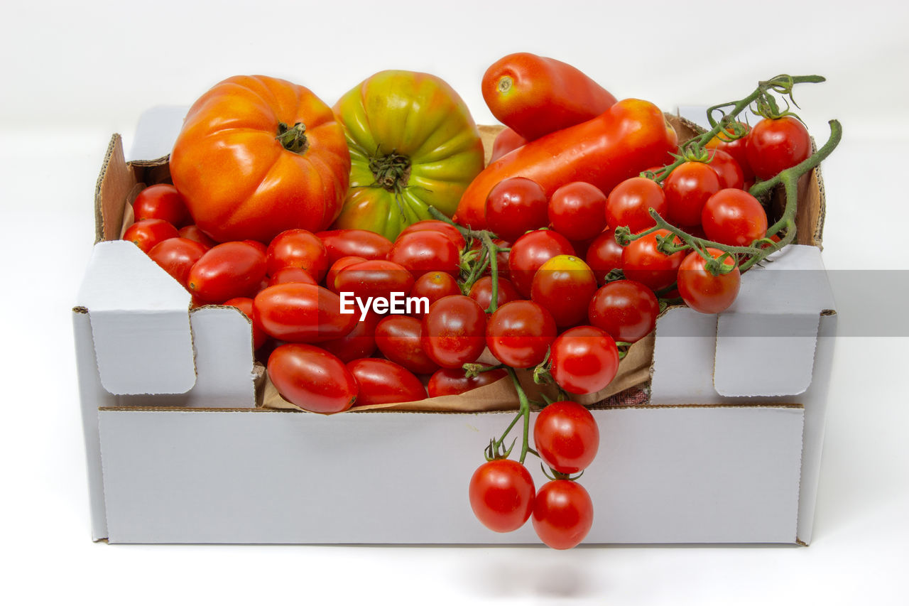 HIGH ANGLE VIEW OF TOMATOES ON RED BACKGROUND