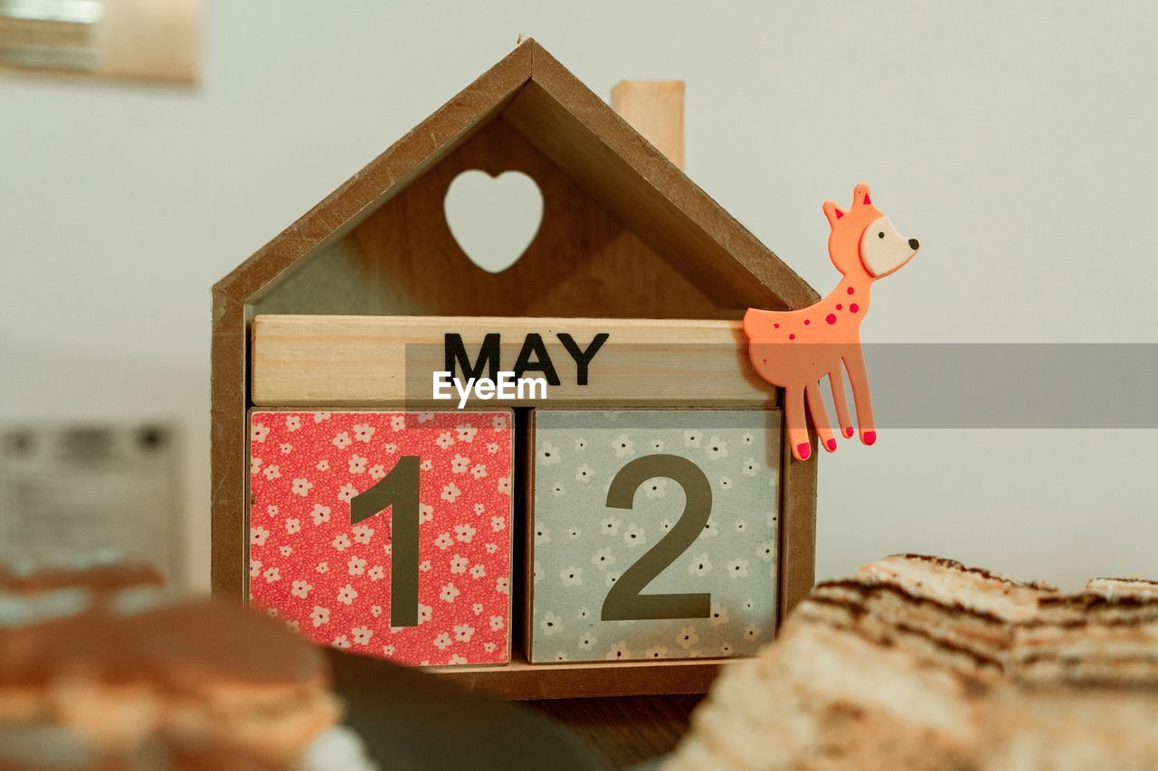 Close-up of wooden calender made of cubes with colorful giraffe 