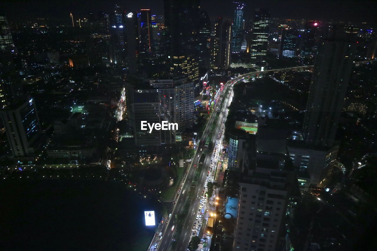 LOW ANGLE VIEW OF CITYSCAPE AT NIGHT