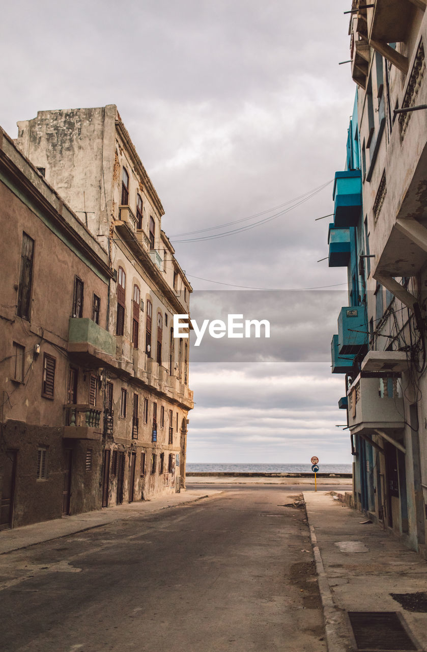 Street amidst buildings against sky in city