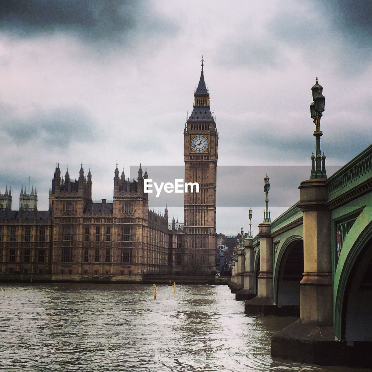 Big ben and city against cloudy sky