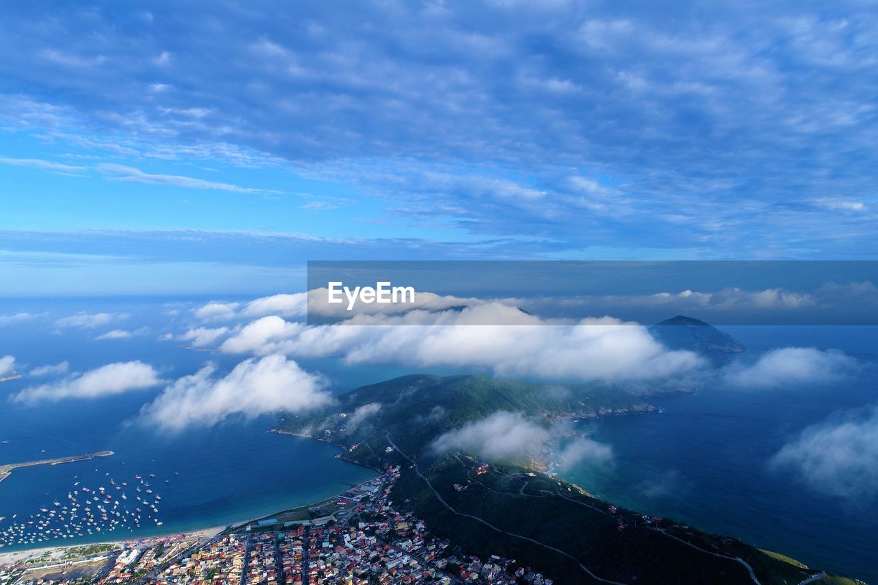 High angle view of sea and land against sky