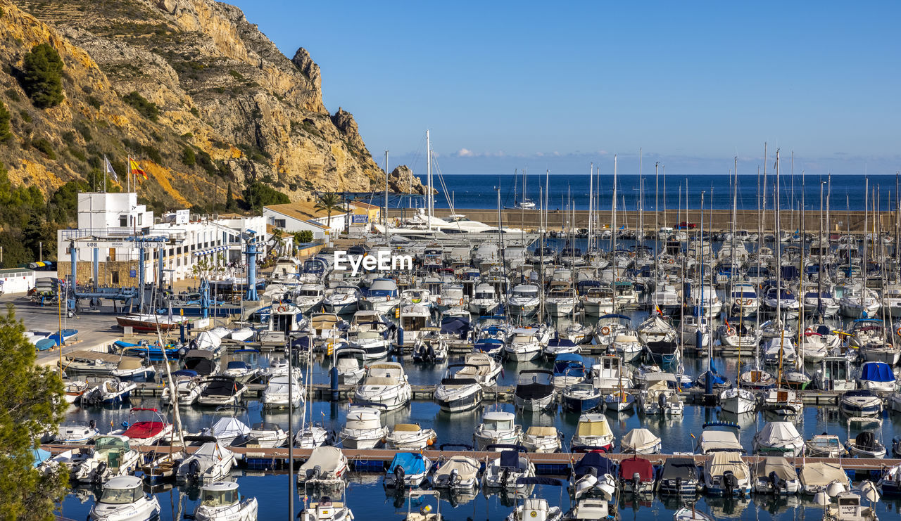 A very busy javea port looking serene and beautiful on another spectacular day in spain.
