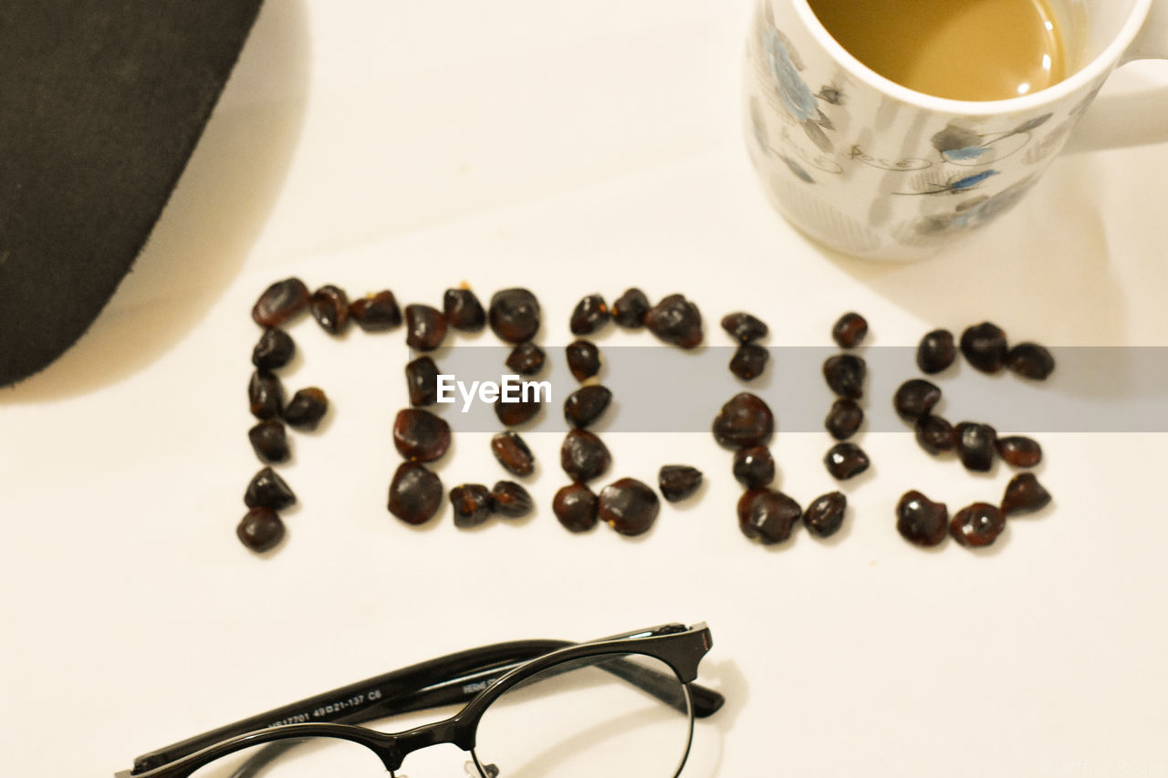 CLOSE-UP OF COFFEE BEANS ON TABLE