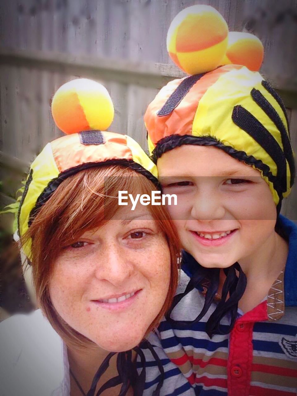 Close-up portrait of smiling woman with daughter winter