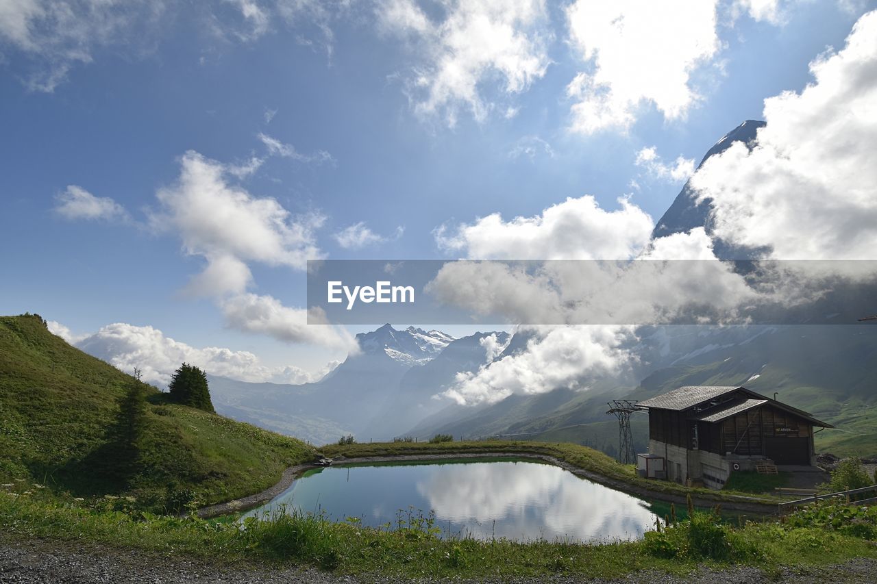 PANORAMIC SHOT OF BUILDINGS AND MOUNTAIN AGAINST SKY