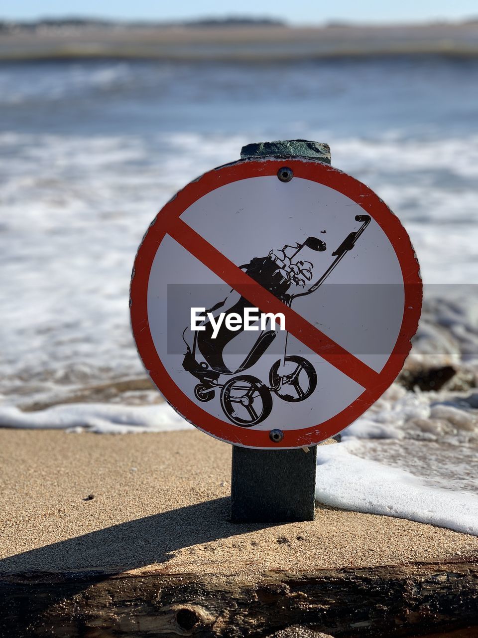 Close-up of sign on beach