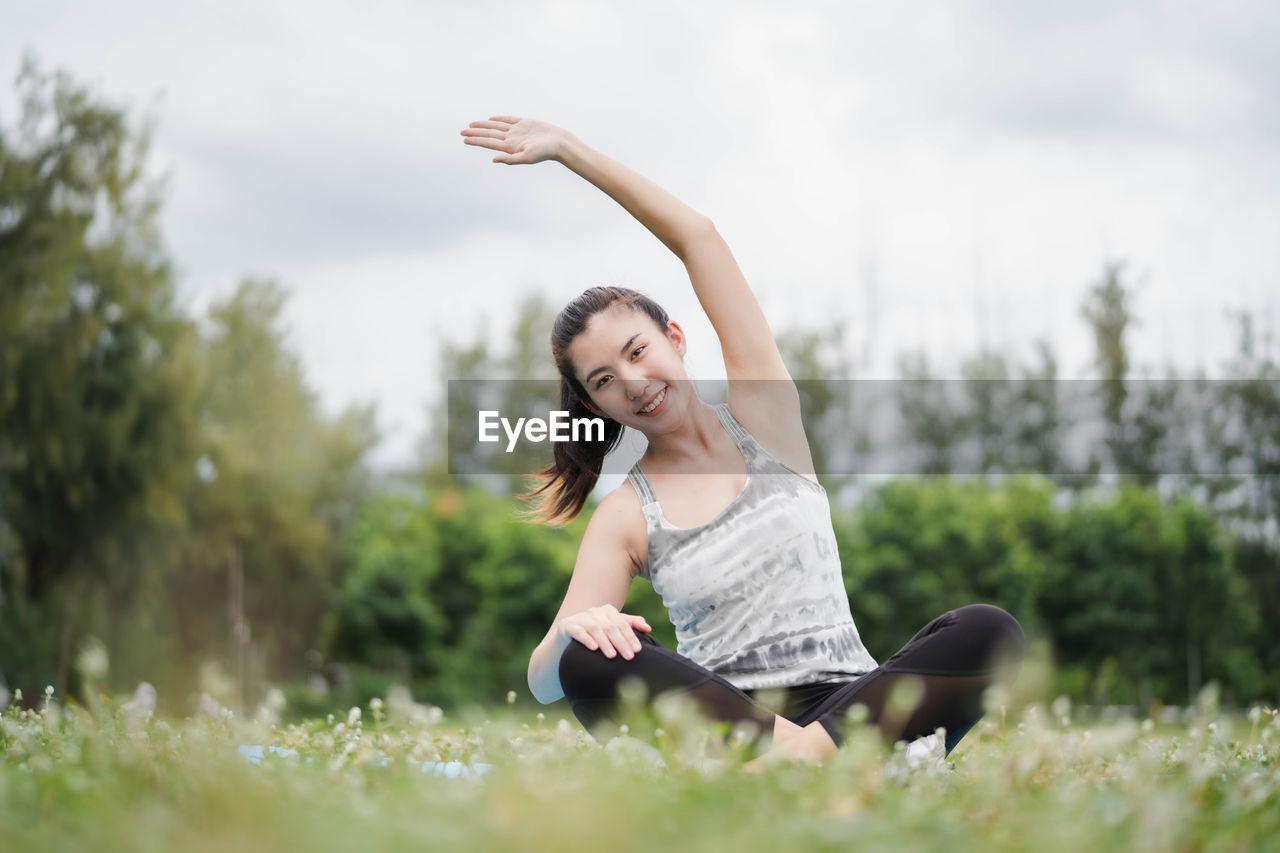 HAPPY WOMAN WITH ARMS RAISED