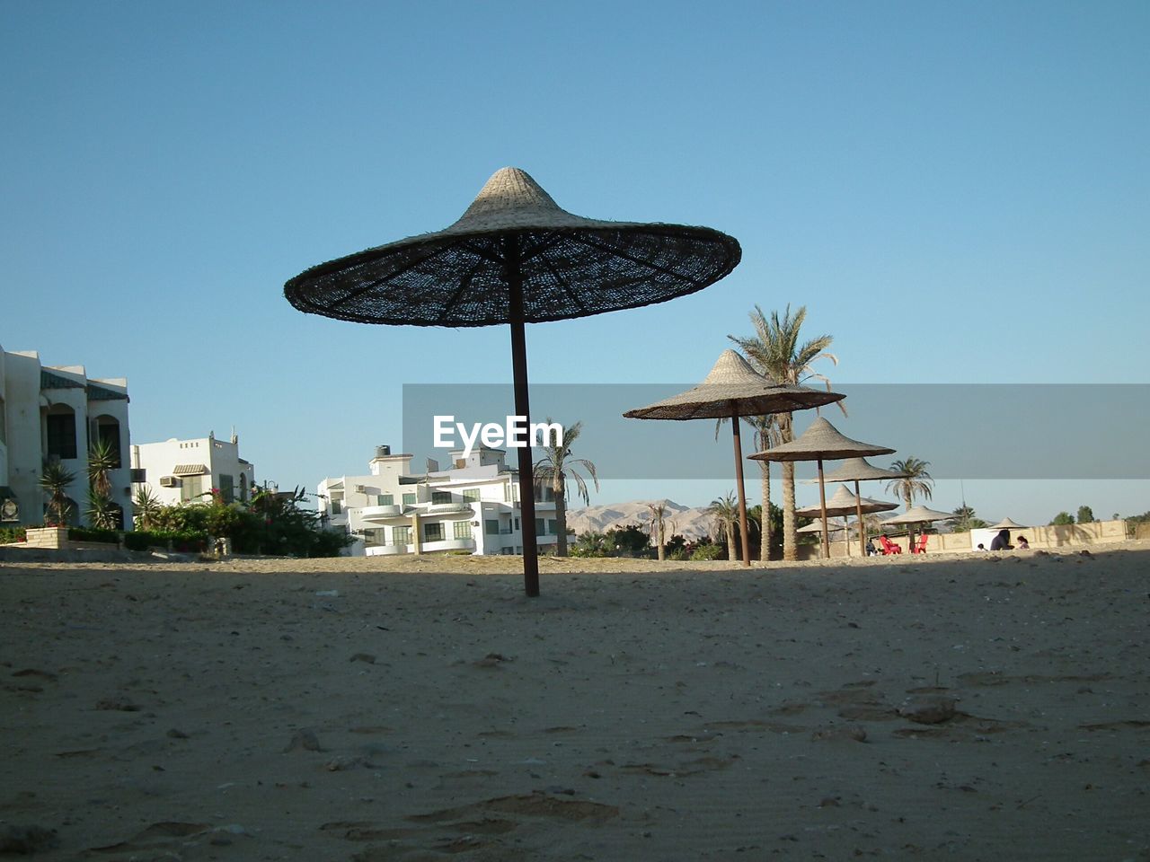 WINDMILL ON BEACH AGAINST CLEAR SKY