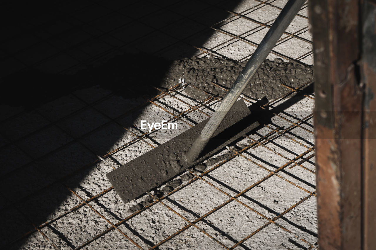 HIGH ANGLE VIEW OF SHADOW OF A CAT ON METAL