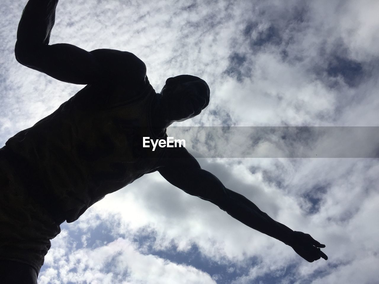 SILHOUETTE OF MAN AGAINST CLOUDY SKY