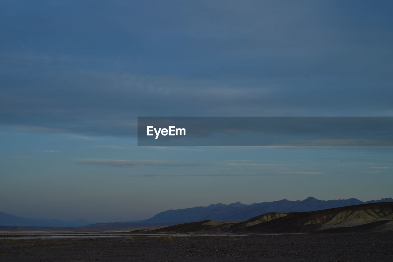 SCENIC VIEW OF BEACH AGAINST SKY DURING SUNRISE