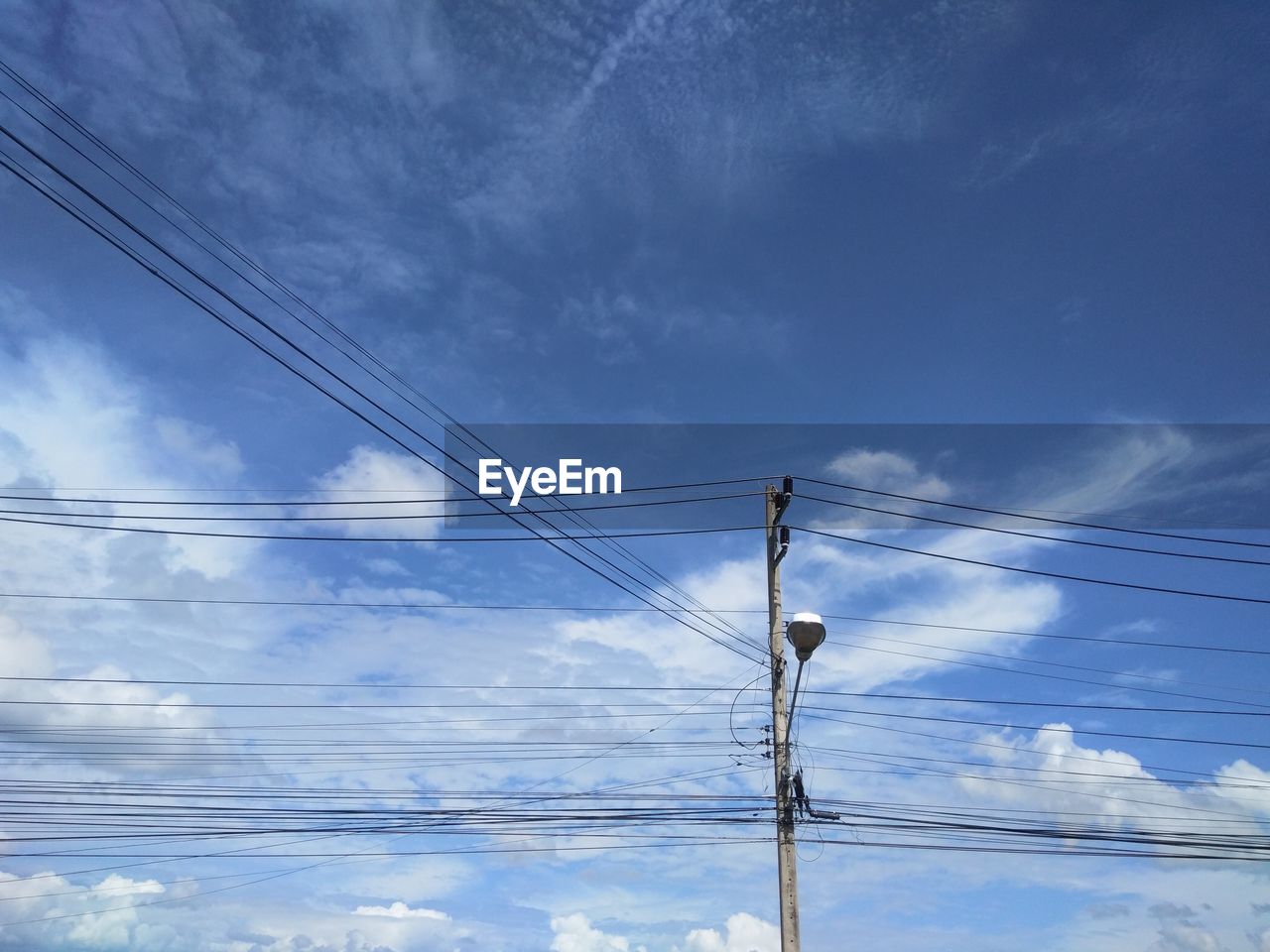 Low angle view of electricity pylon against sky