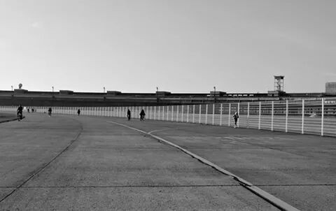 WOMAN STANDING BY RAILING