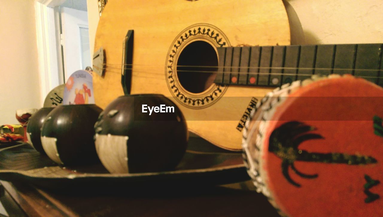 CLOSE-UP OF GUITAR WITH BALL AND TABLE