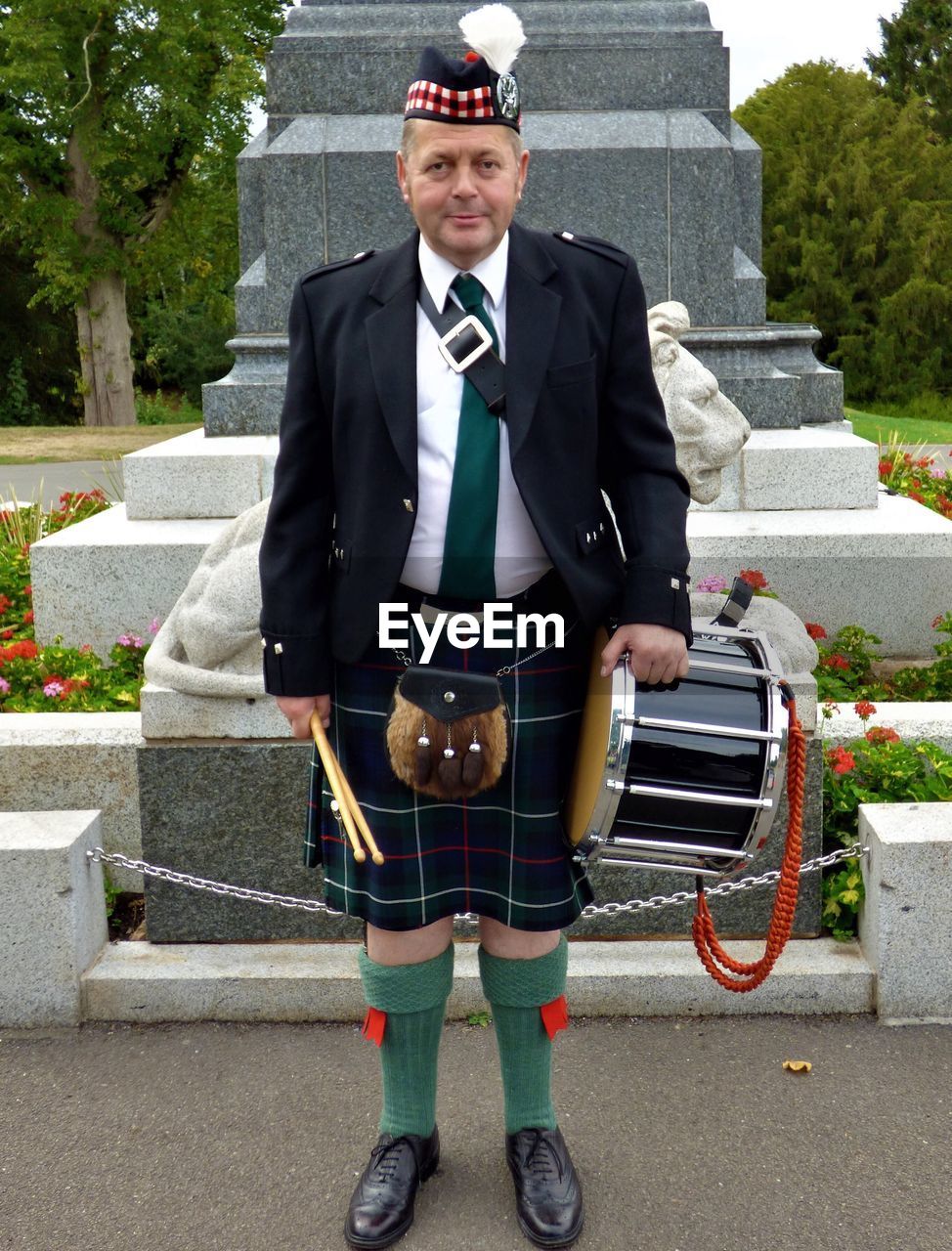 Portrait of drummer standing outdoors