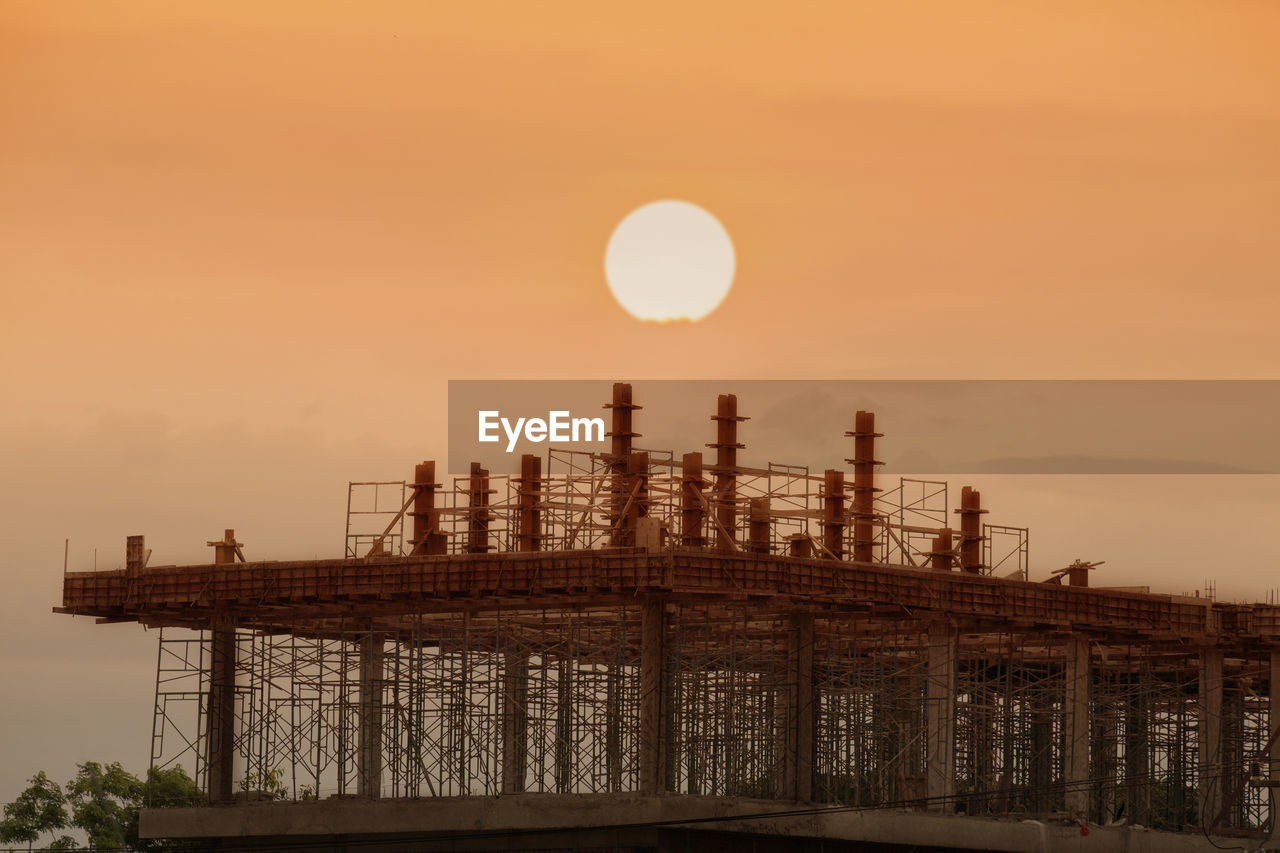 View of factory against sky during sunset