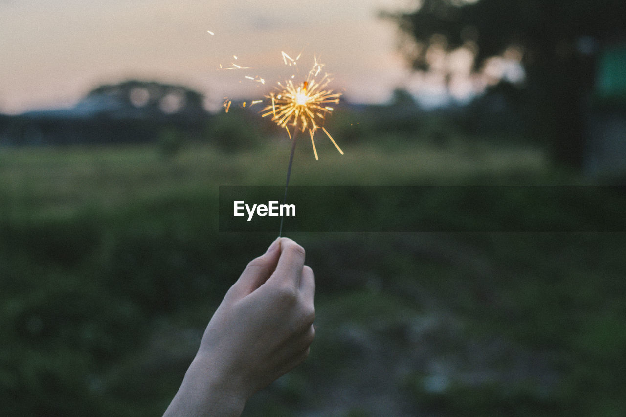 Close-up of person holding sparkler