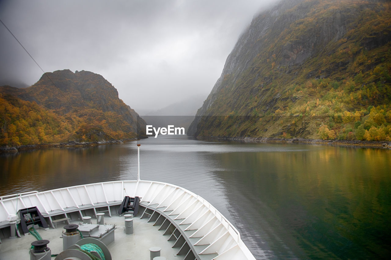 water, reflection, nature, scenics - nature, beauty in nature, environment, mountain, fog, no people, sky, nautical vessel, lake, travel, transportation, travel destinations, land, landscape, cloud, tranquility, outdoors, tranquil scene, tourism, morning, tree, autumn