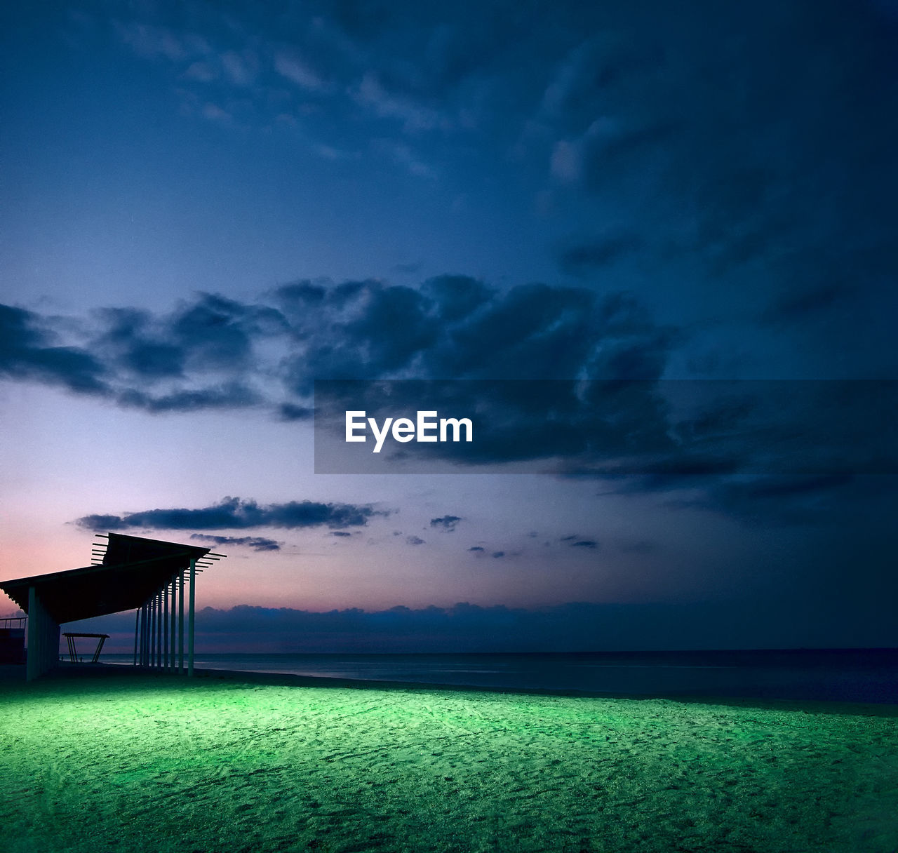 Scenic view of field against sky at sunset