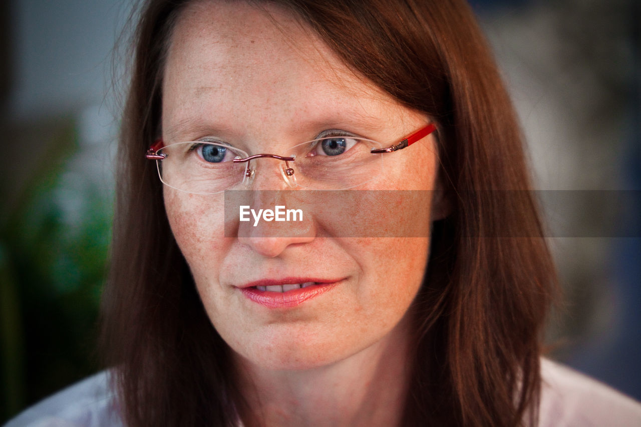 Woman in eyeglasses looking away