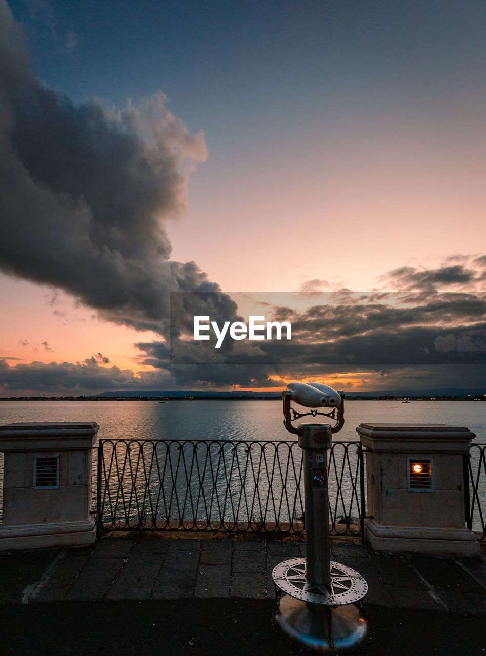 Panoramic sea binoculars with spectacular sunset in the background