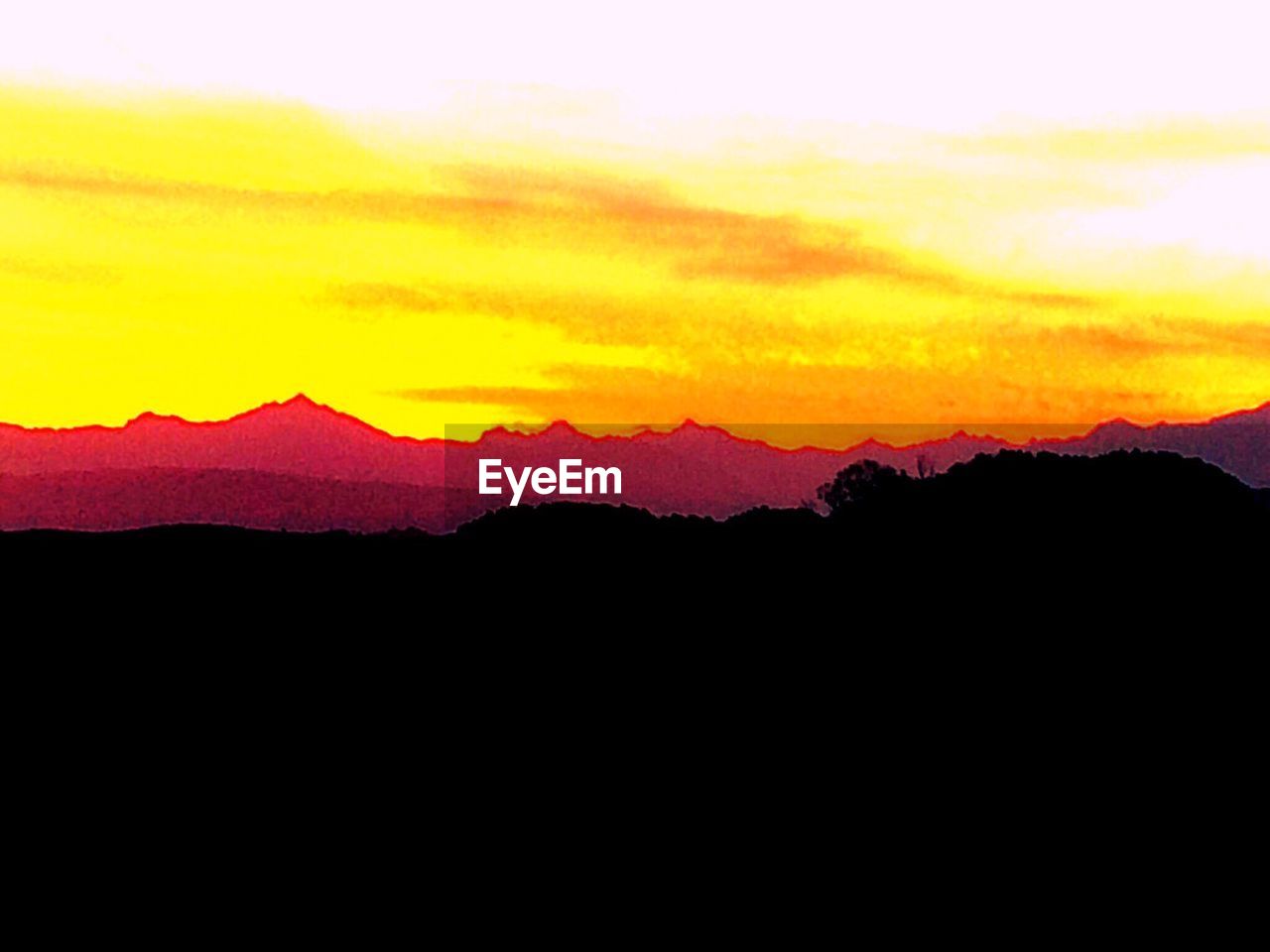 SILHOUETTE MOUNTAINS AGAINST SKY DURING SUNSET