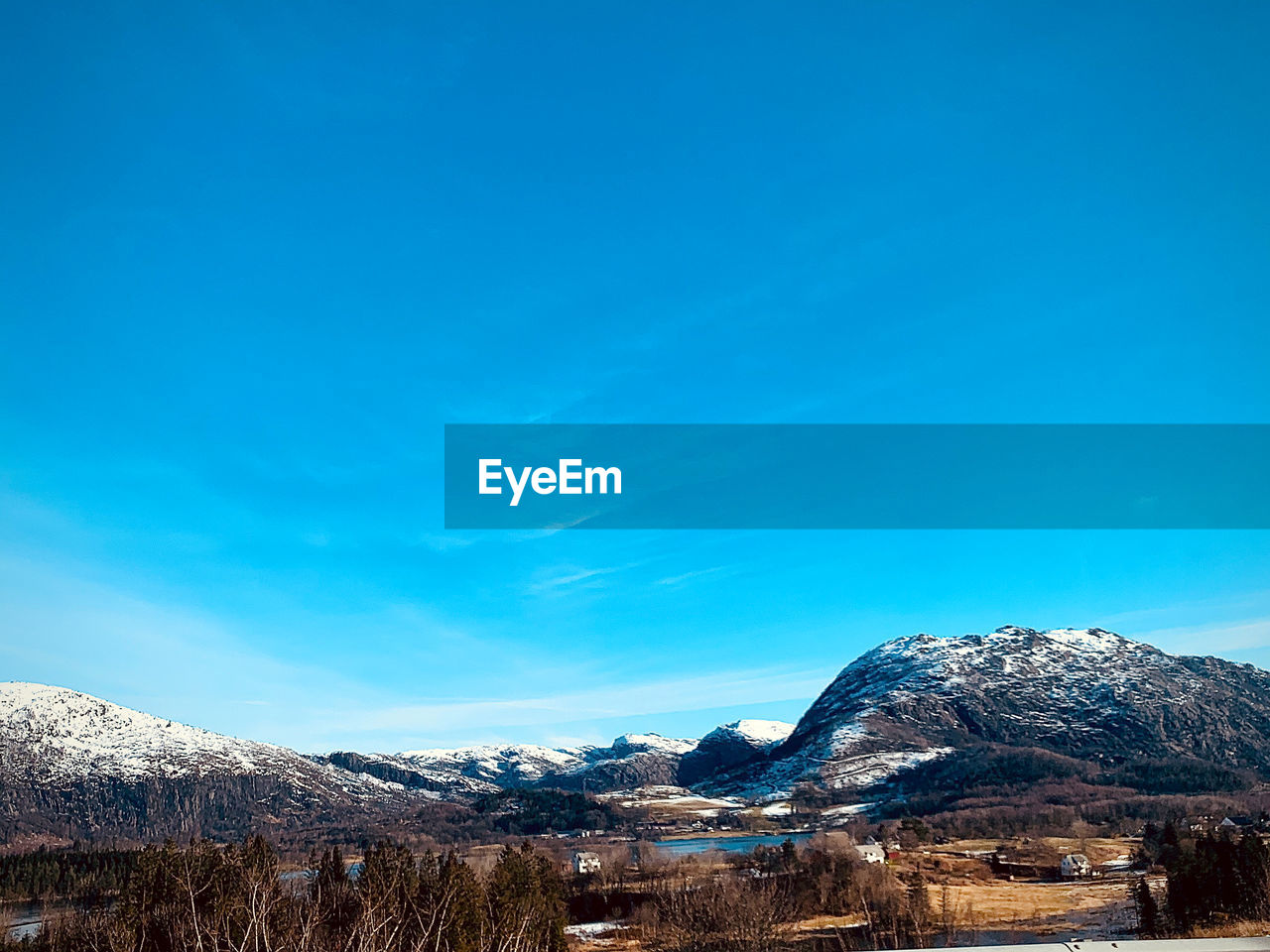 SNOWCAPPED MOUNTAINS AGAINST BLUE SKY