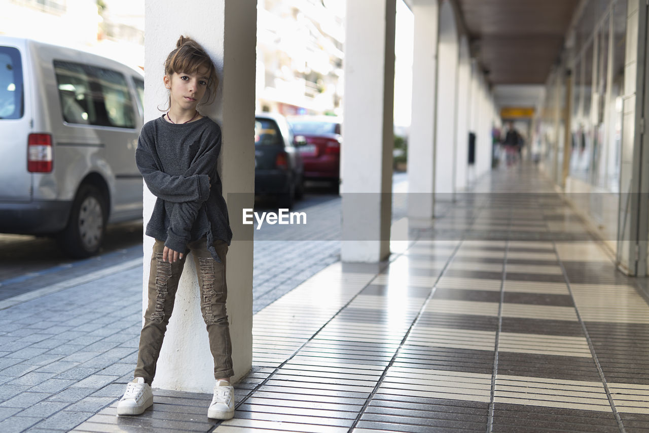 Portrait of girl standing in corridor