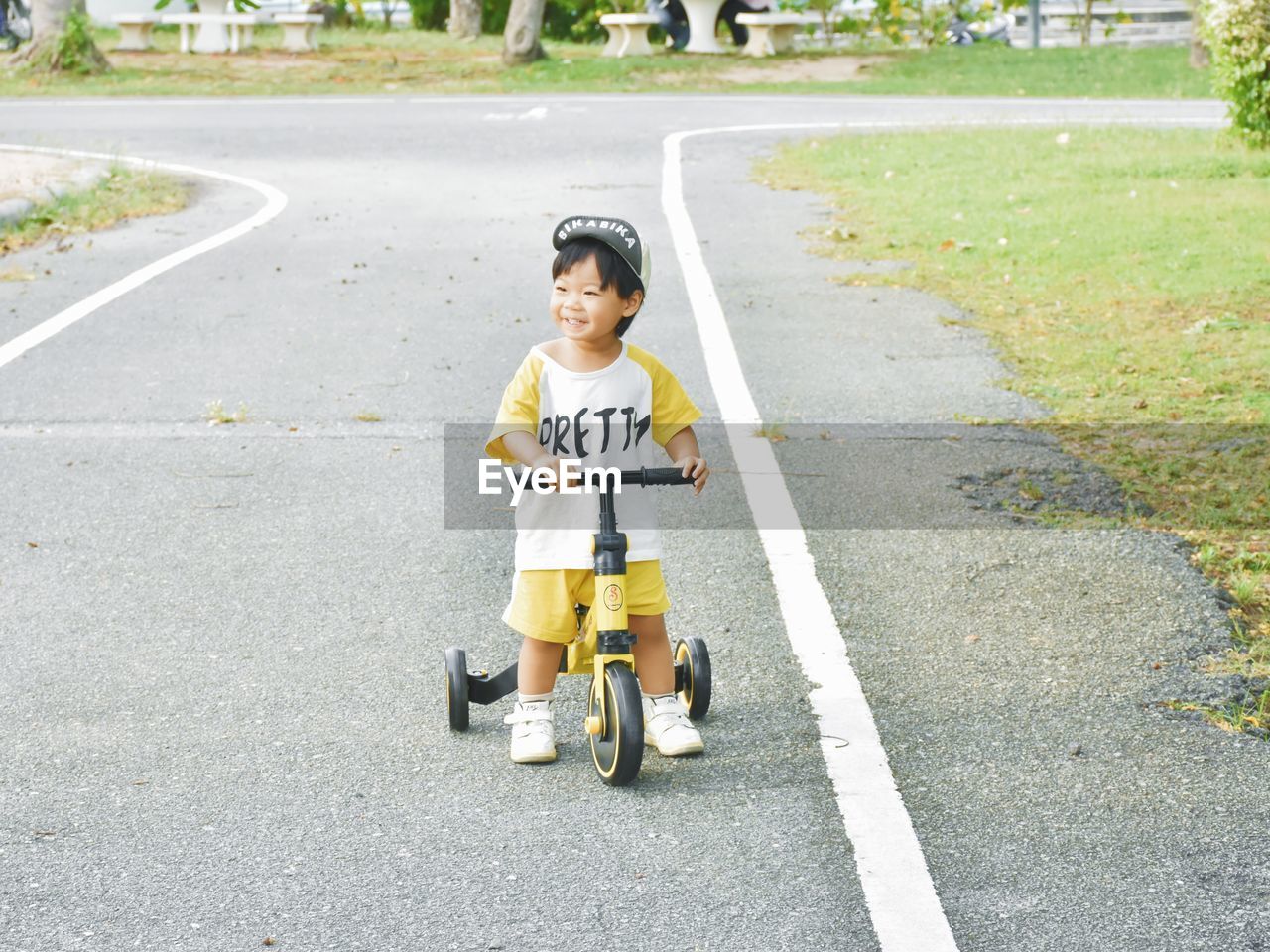 Portrait of woman riding push scooter on road