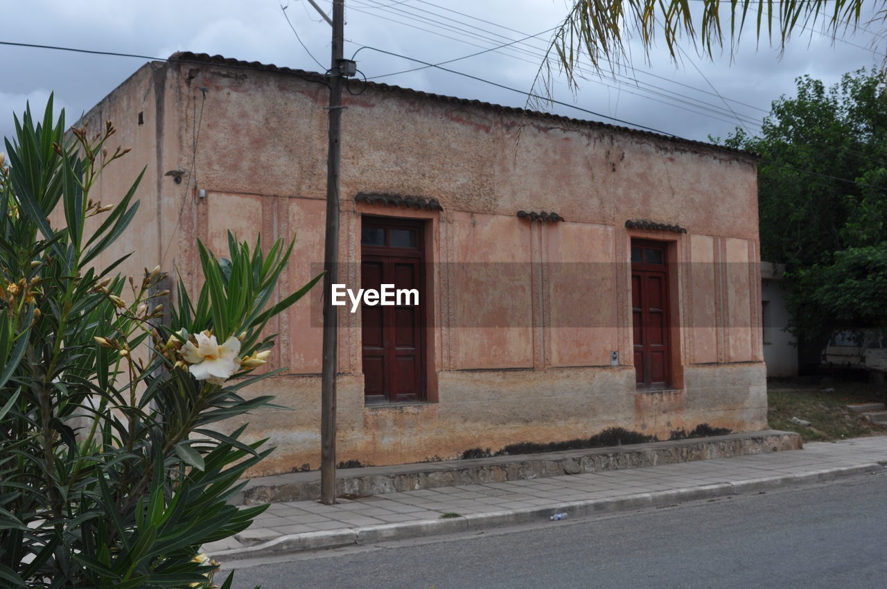 Exterior of building by road against sky